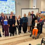 Zdjęcie grupowe uczestników konferencji, w tle powstała grafika tworzona na żywo w trakcie konferencji.